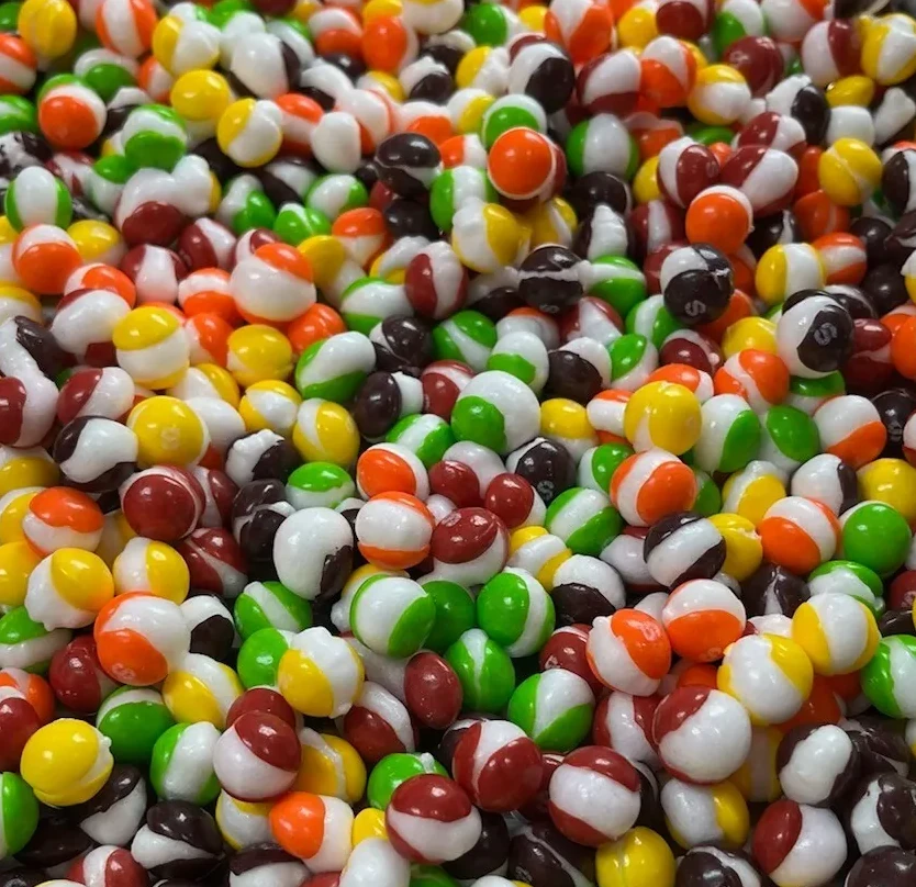 Close-up of colorful freeze-dried Skittles with a crunchy texture.