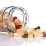 Freeze-dried fruit and nut mix spilling from a glass jar, perfect for healthy freeze-dried recipes.