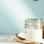 Coconut oil in a glass jar with coconut pieces, ideal for making coconut oil tinctures.