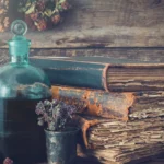 Rustic glass bottle with herbs and vintage books, representing herbs for winter wellness and traditional herbal practices.